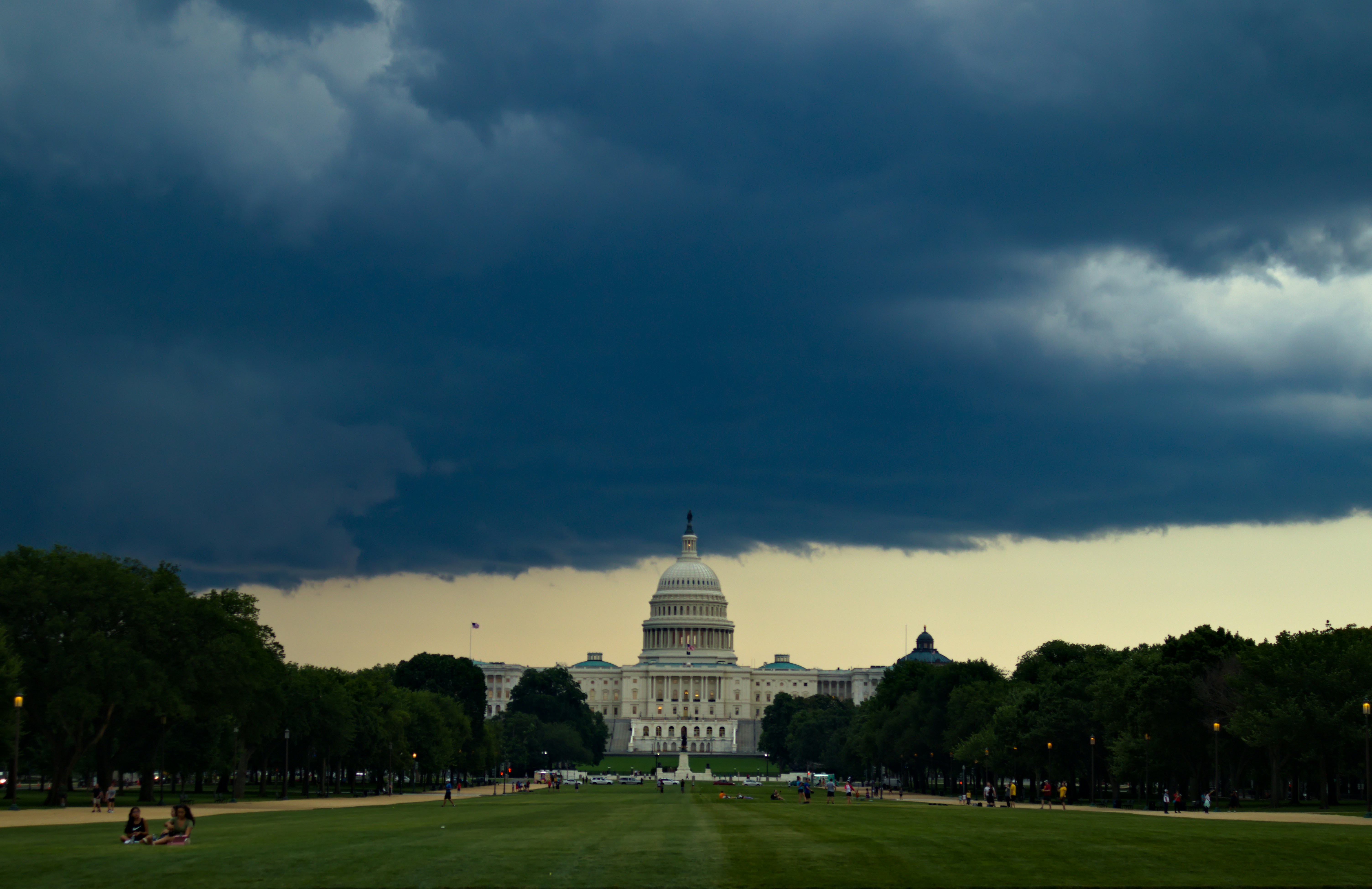A dark thunderstorm cloud over the Washington DC skyline with rain starting to fall