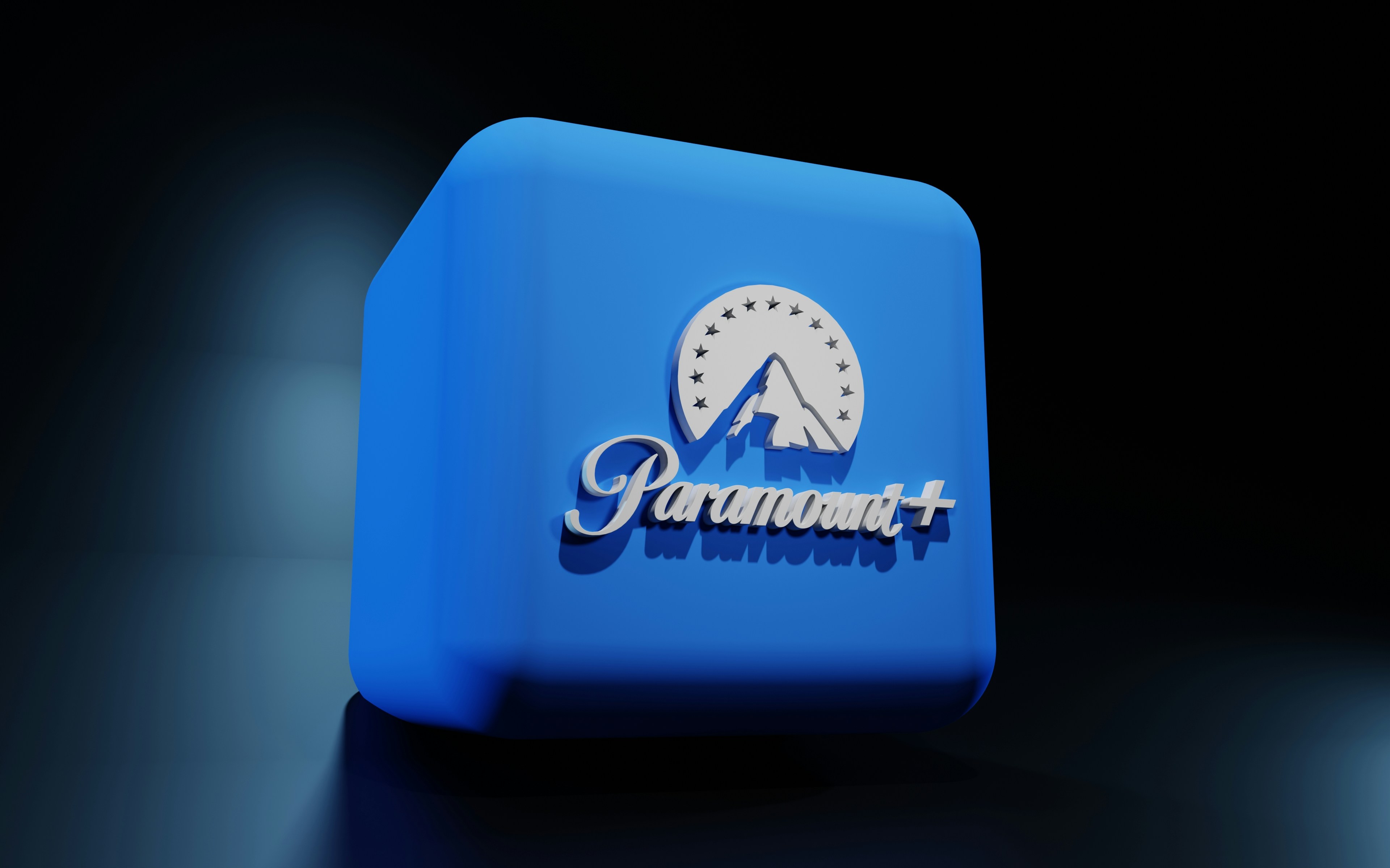 A stylized image of a movie studio backlot with a large Paramount-style gate, overlaid with a subtle question mark and a smartphone showing an incoming text message.