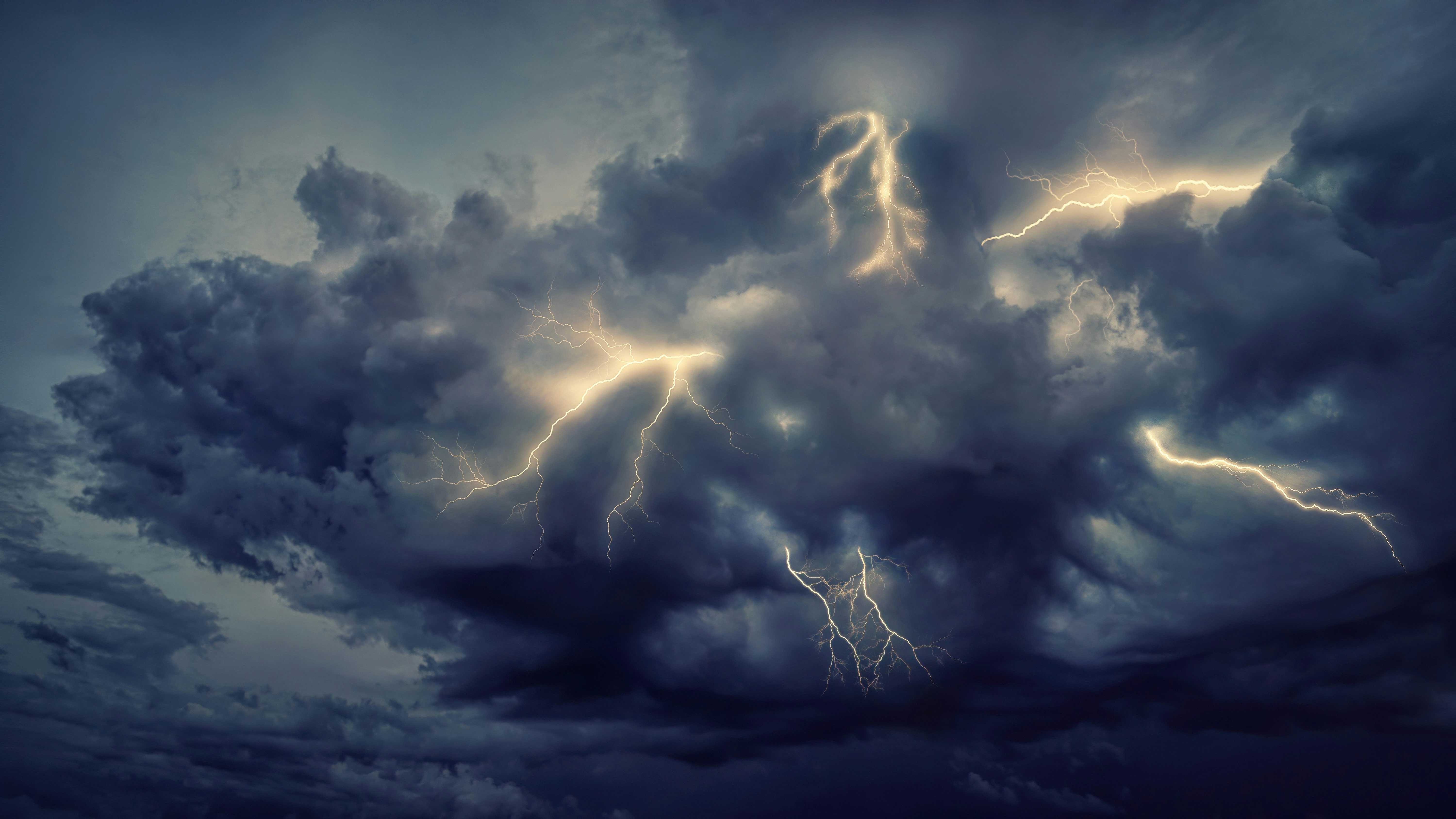 A dark storm cloud over a suburban neighborhood with lightning in the distance, while a smartphone screen displays an incoming text message alert.
