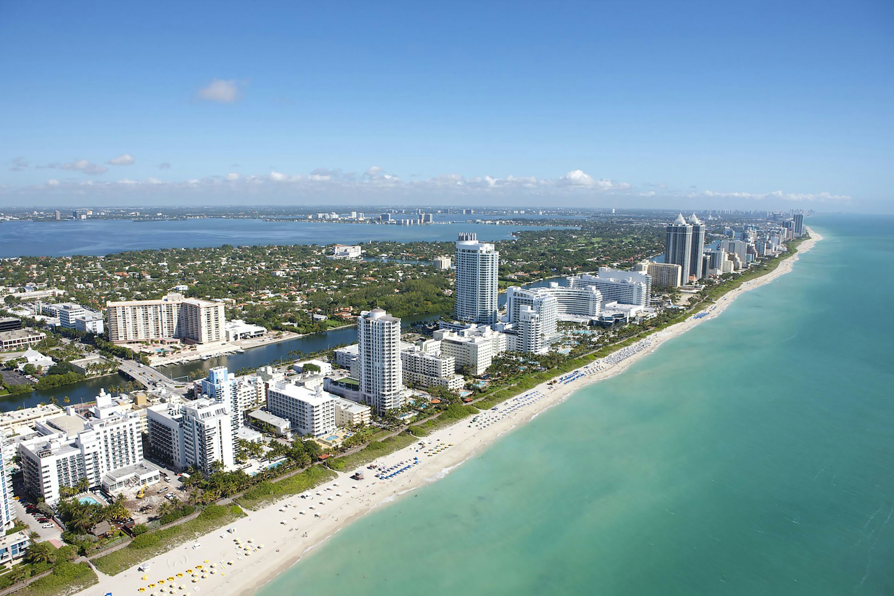 An aerial view of the coastline and high-rise buildings in Miami Beach, Florida